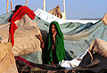 refugee woman among the makeshift tents at Jalozai